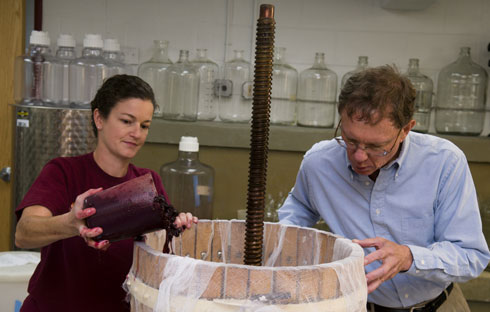 Bruce Zoecklein and Lisa Pelanne, a research associate in the Department of Food Science and Technology, prepare a sample of wine in the Virginia Tech Wine Lab.
